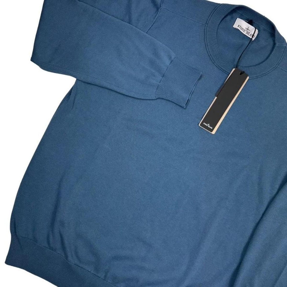 Stone Island blue organic cotton knit jumper with logo patch and ribbed cuffs.