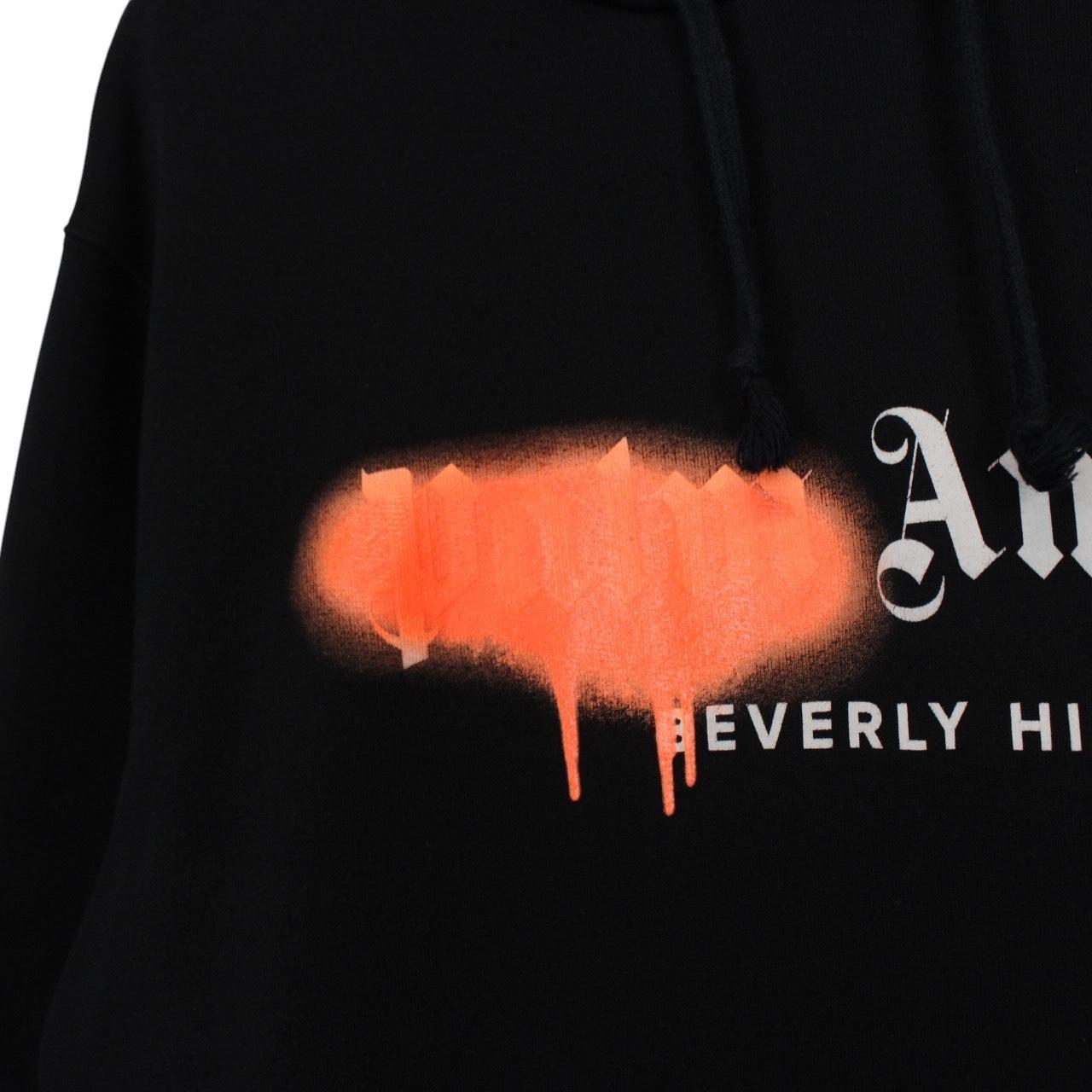 Palm Angels black and orange hoodie with Beverly Hills spray design and cotton material.