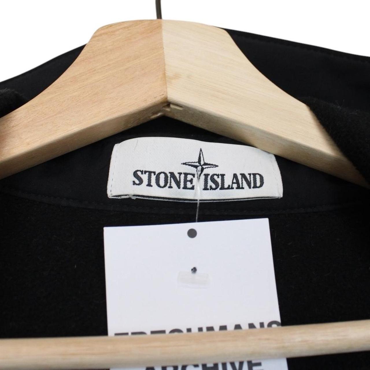 Stone Island black soft shell jacket with full zip and iconic compass logo.