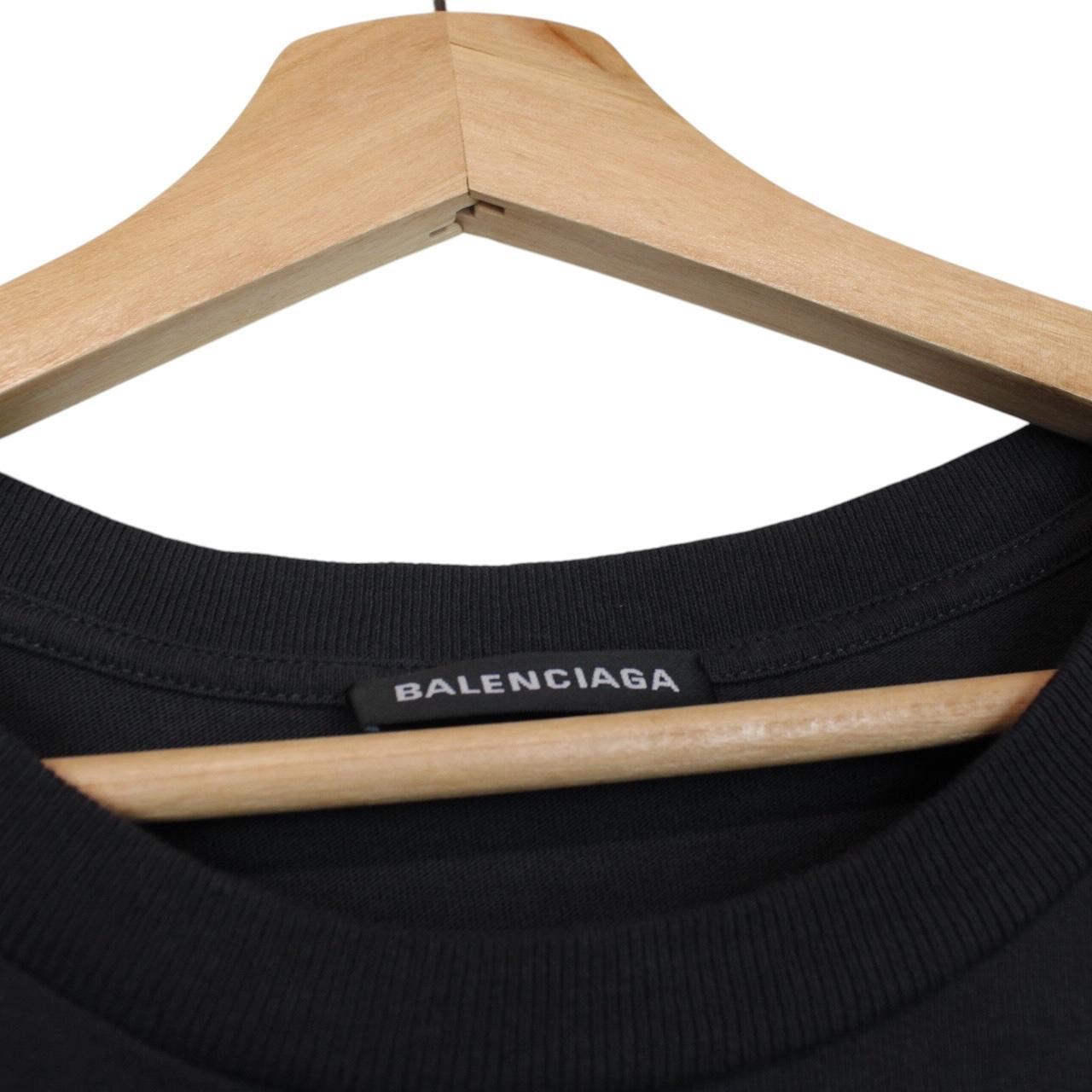 Balenciaga black oversized pocket t-shirt with bold logo print on front.