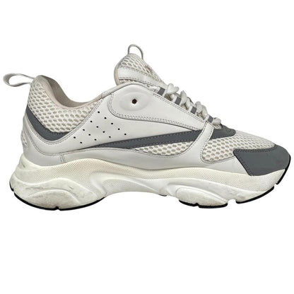 Dior grey and white trainers with logo detailing and worn soles.