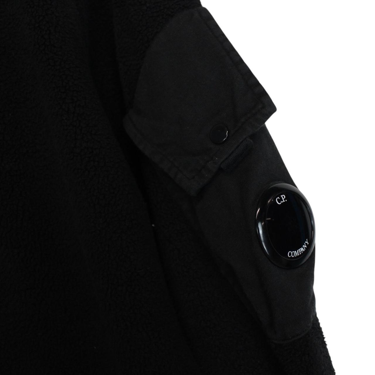 CP Company black fleece jumper with raglan sleeves and iconic lens detail.
