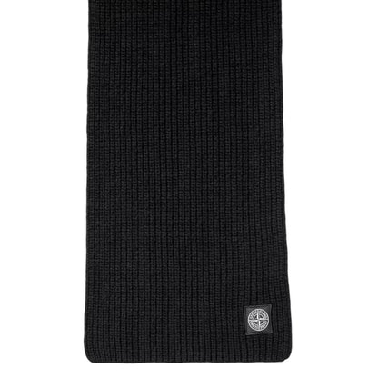 Stone Island black wool scarf with ribbed texture and embroidered logo patch.