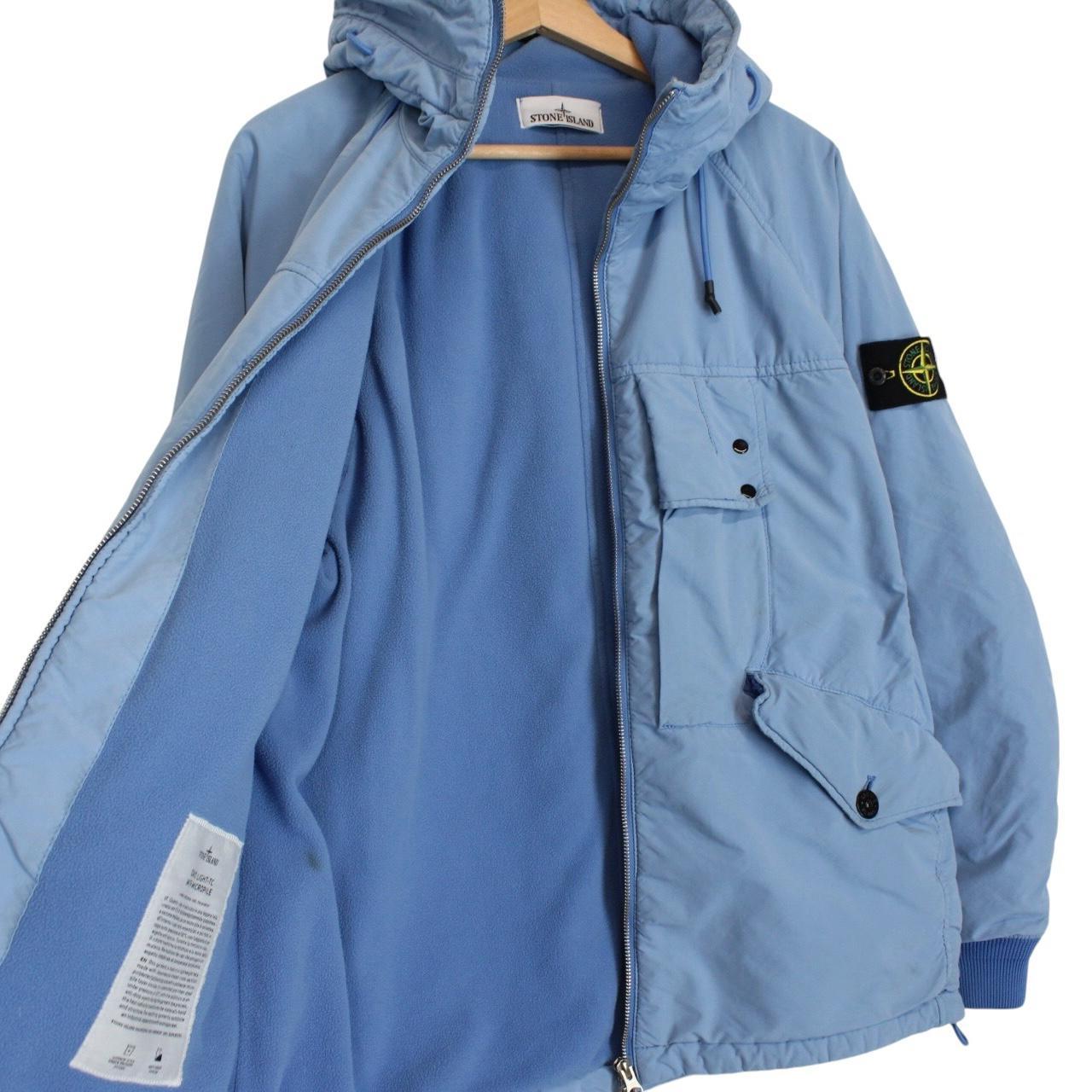 Stone Island blue jacket with logo patch and micropile texture, size small.