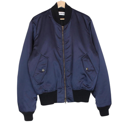 Balenciaga navy bomber jacket with full zip and campaign logo on chest.