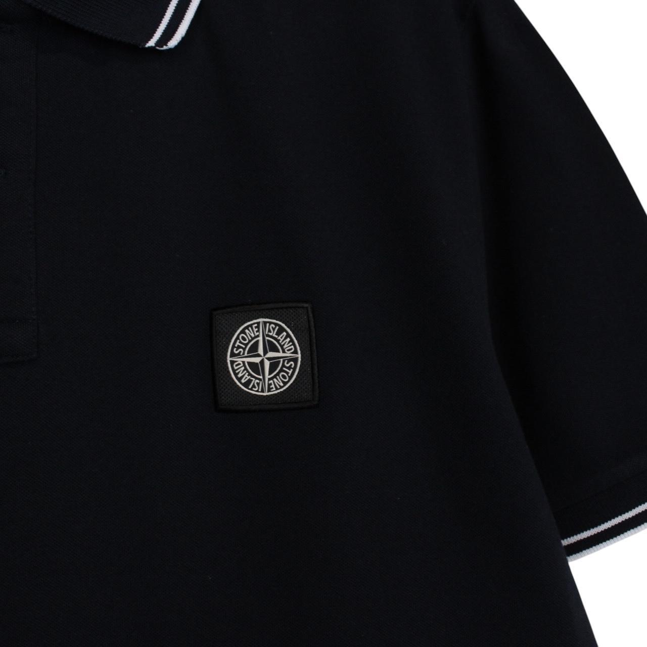 Stone Island navy blue short sleeve polo shirt with compass logo and cotton material.