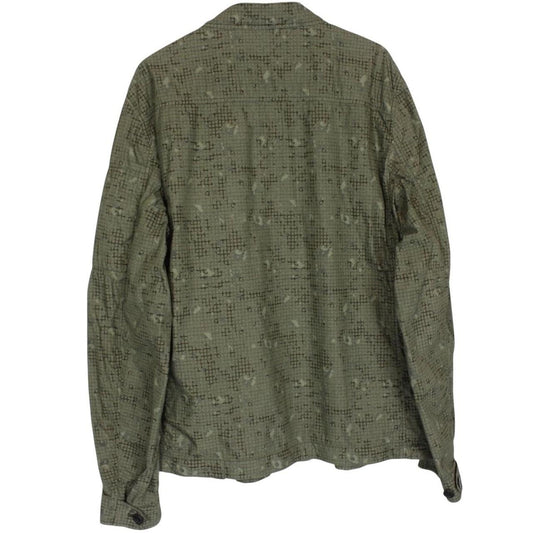 CP Company khaki green overshirt jacket with digital camouflage pattern and lens detail.