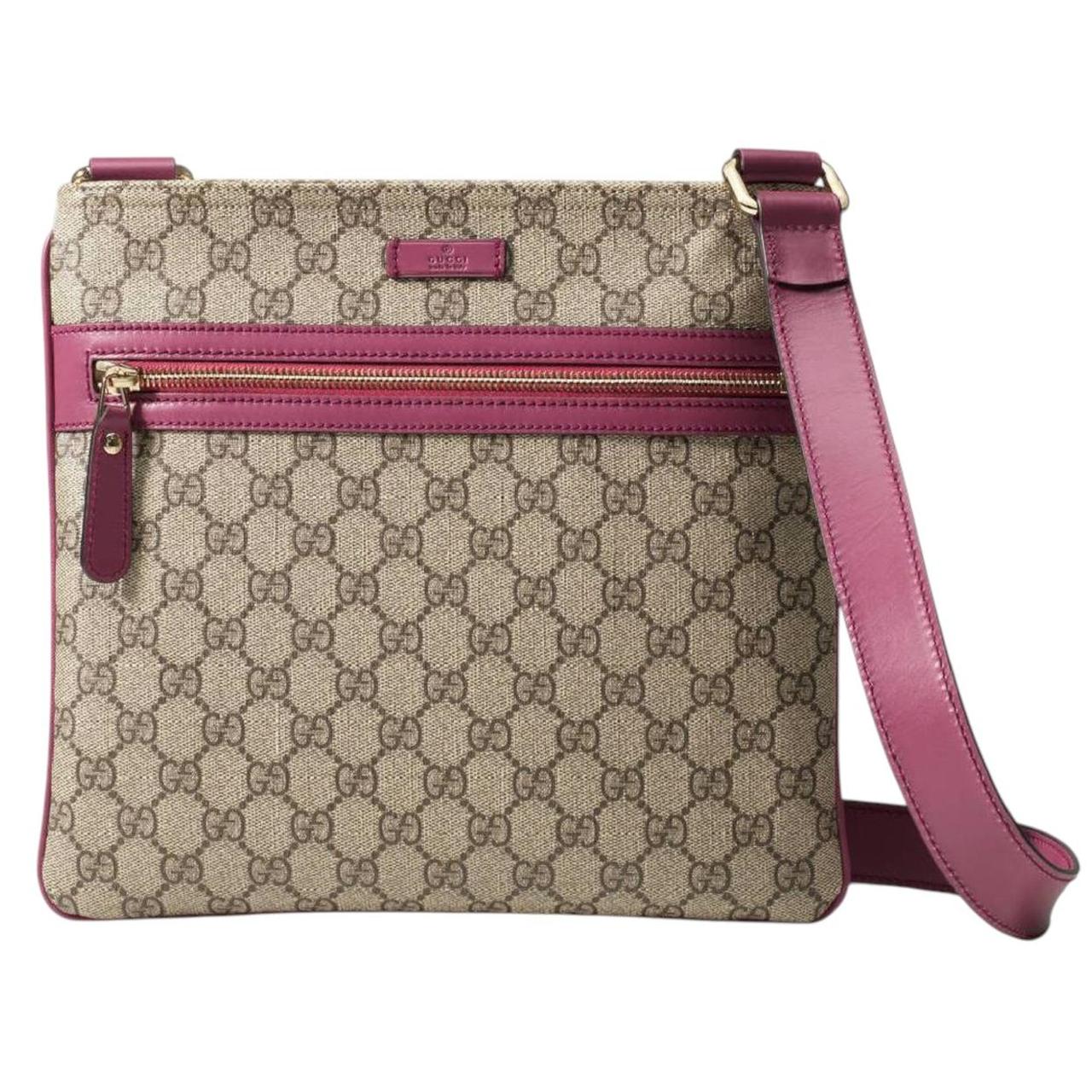 Gucci beige and pink duffel bag with GG Supreme monogram canvas pattern.