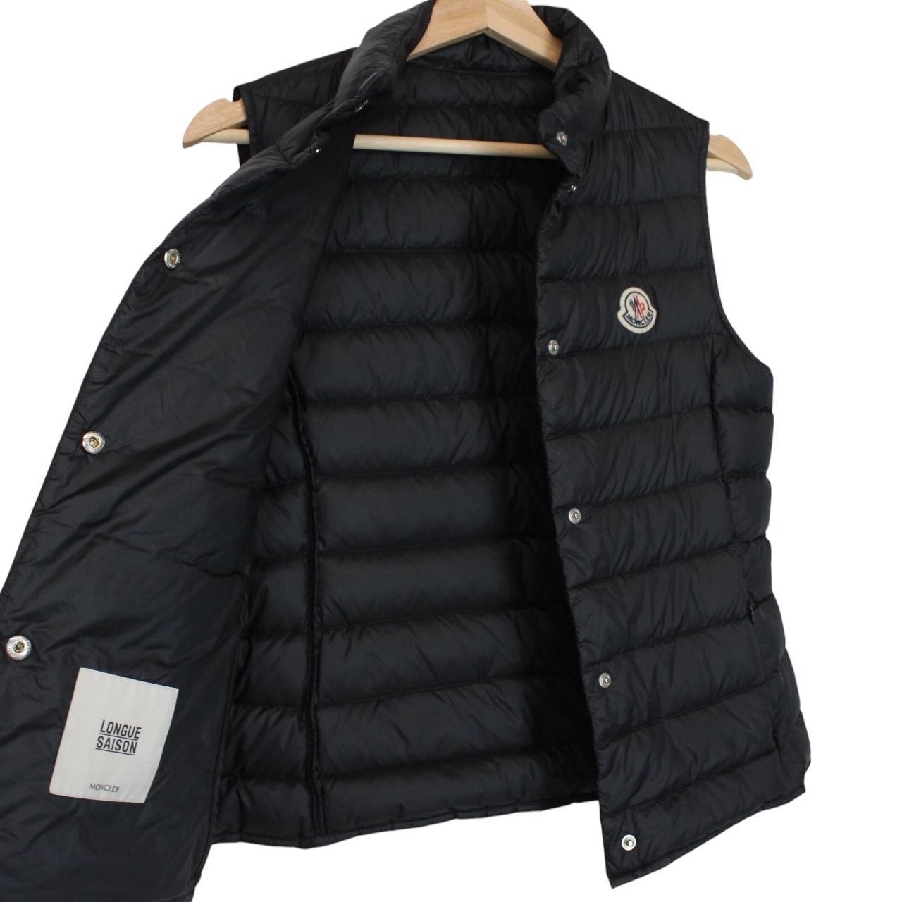 Moncler black quilted shell down gilet with logo patch and zip pockets.