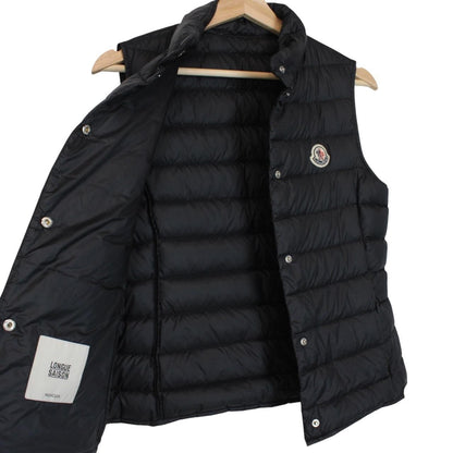 Moncler black quilted shell down gilet with logo patch and zip pockets.