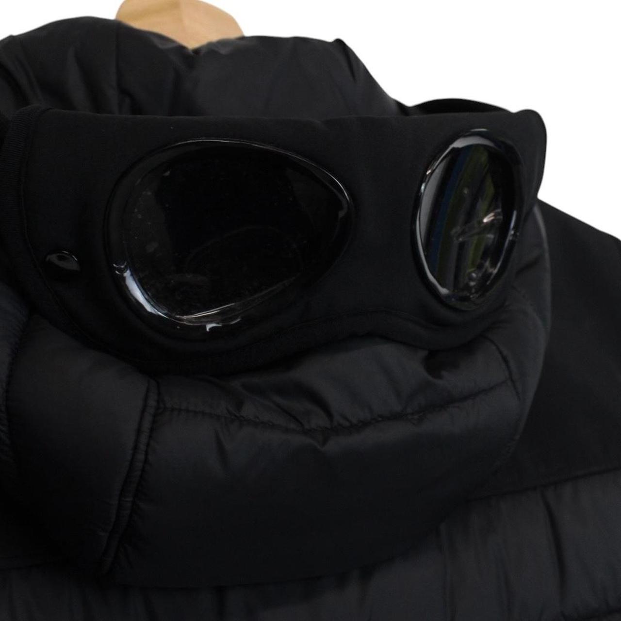 CP Company black goggle gilet with logo detail and shell material.