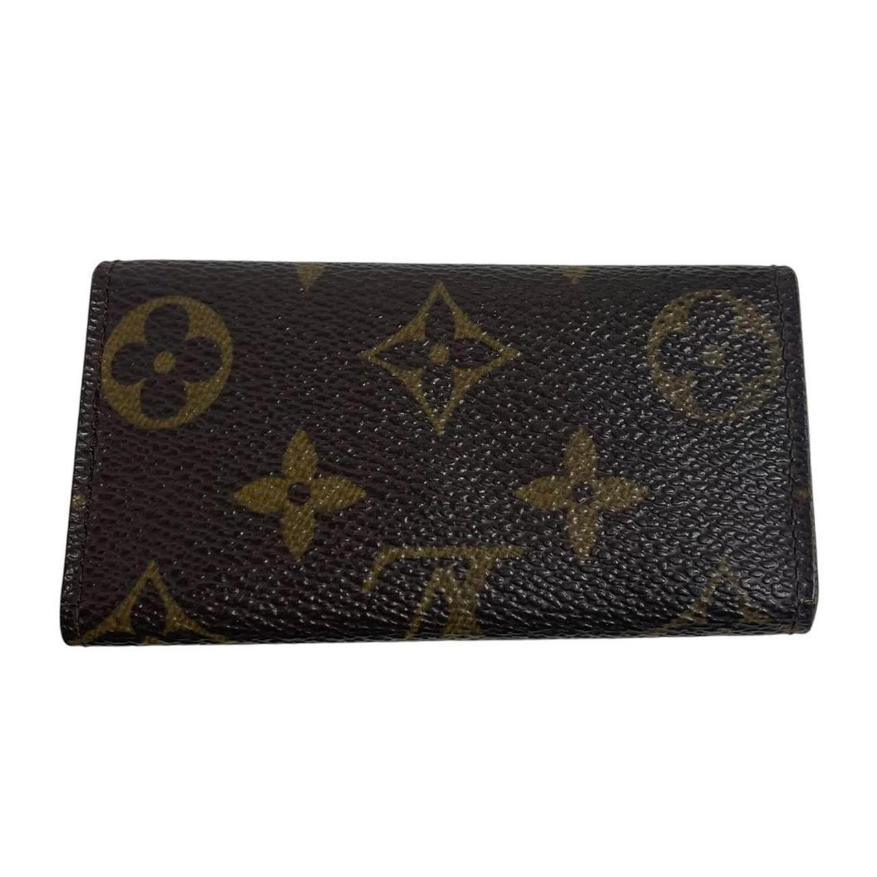 Louis Vuitton brown and tan monogram canvas key case with logo detail.