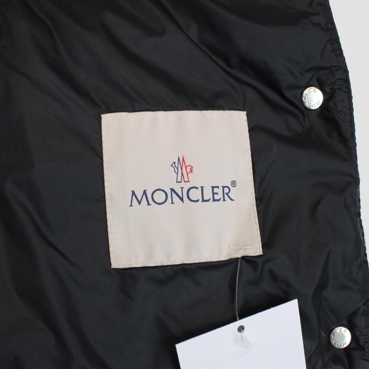 Moncler black quilted shell down gilet with logo patch and zip pockets.