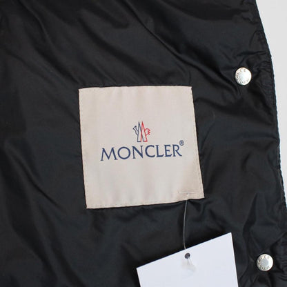 Moncler black quilted shell down gilet with logo patch and zip pockets.