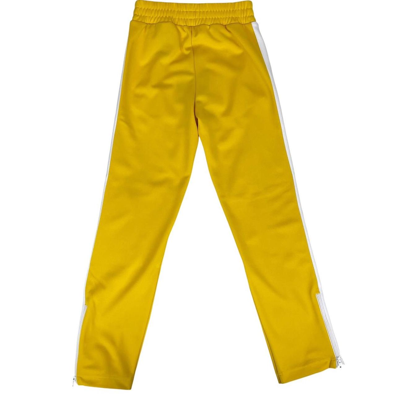 Palm Angels white and yellow joggers with logo detailing and classic fit.