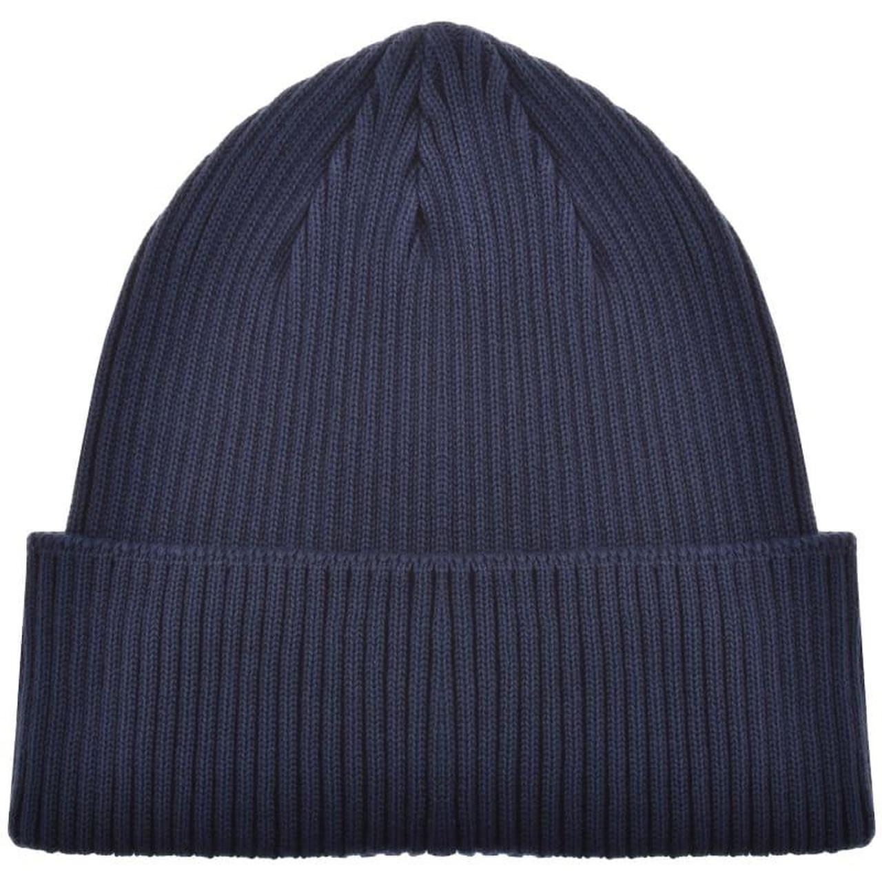 CP Company navy blue beanie hat with goggle detail and cotton material.
