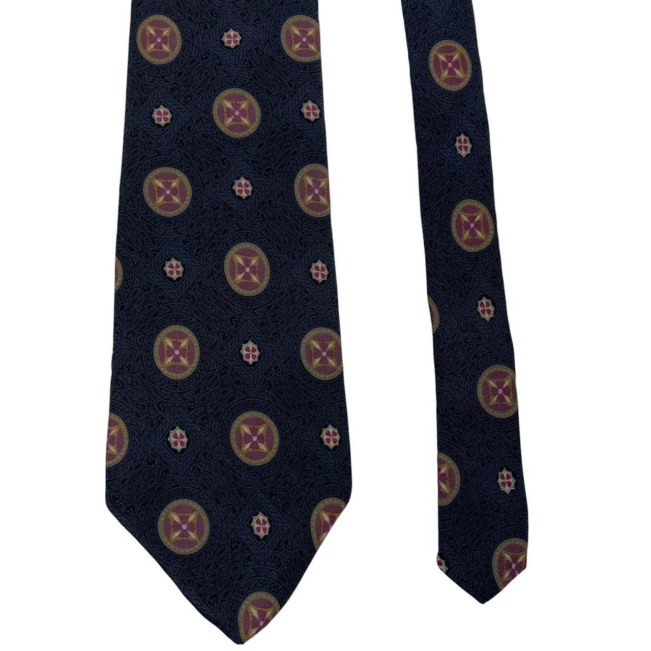 Yves Saint Laurent navy blue silk tie with abstract print design.
