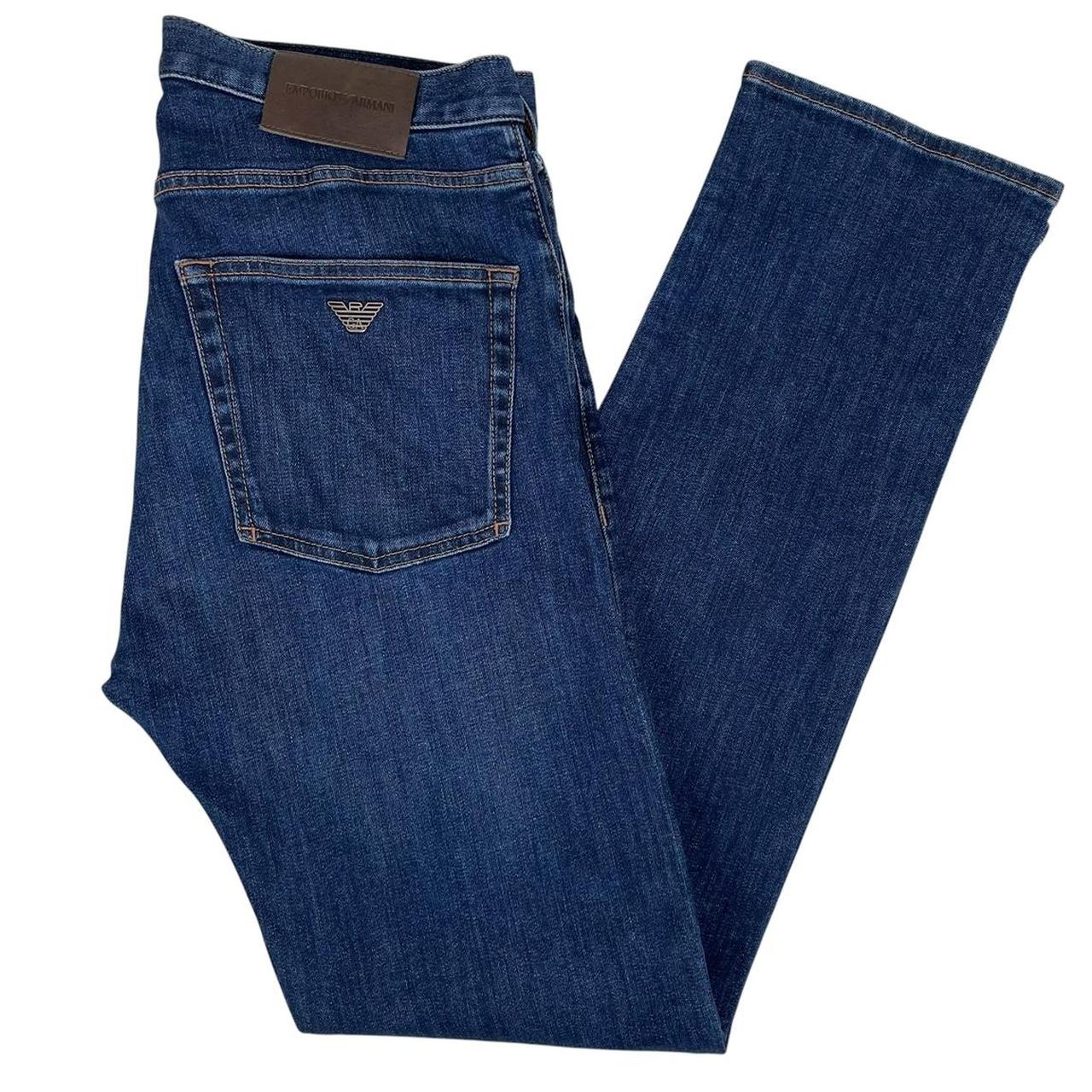 Emporio Armani navy blue slim fit denim jeans with logo patch and classic five-pocket design.