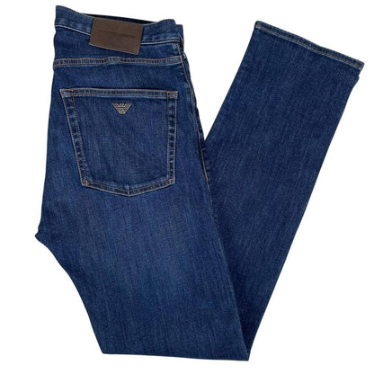 Emporio Armani navy blue slim fit denim jeans with logo patch and classic five-pocket design.