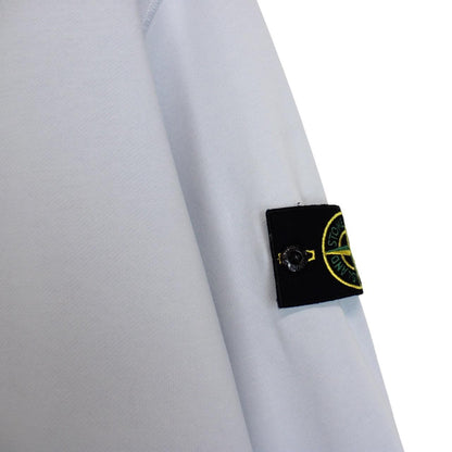 Stone Island blue cotton sweatshirt with logo patch and faded left sleeve.