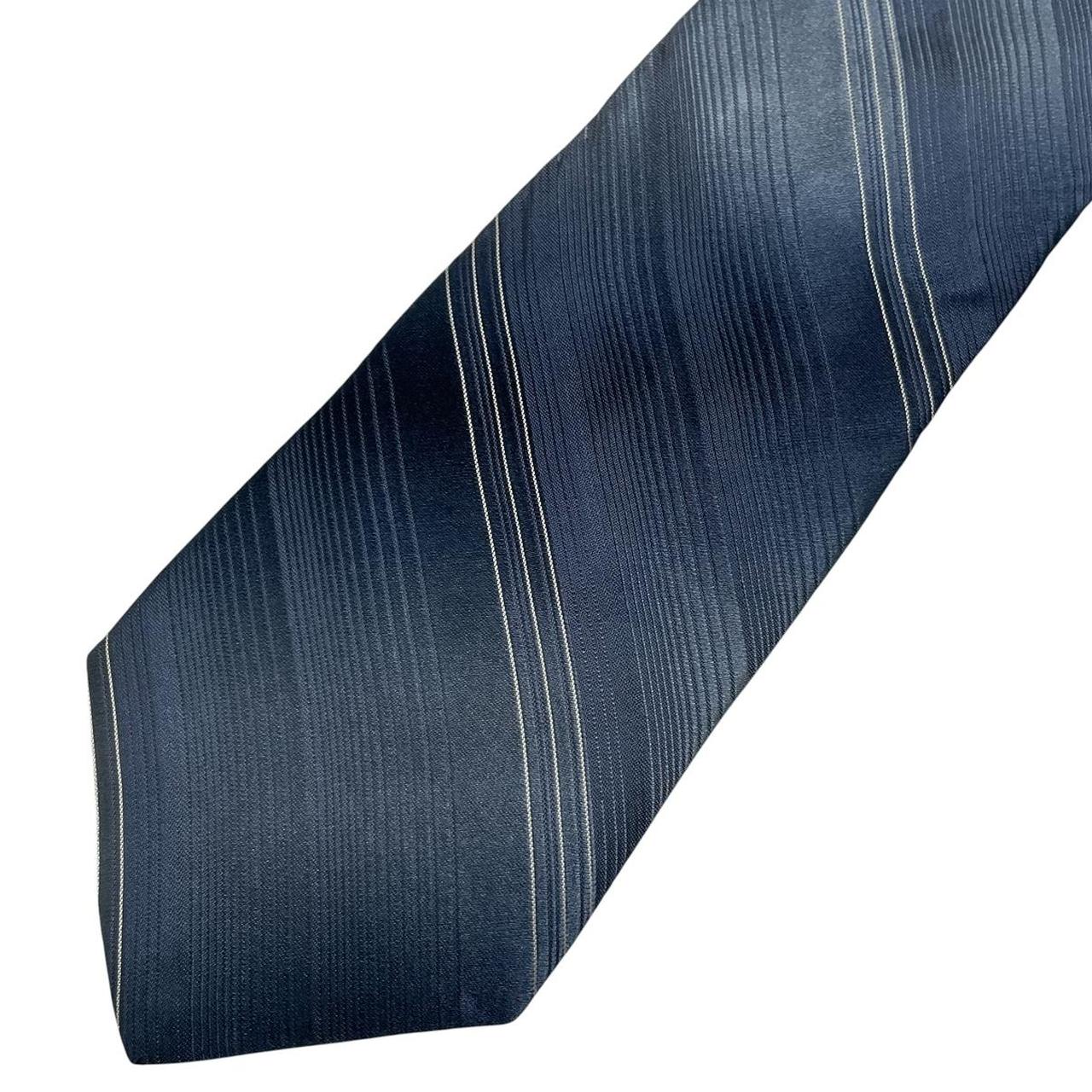 DKNY blue striped silk tie with elegant sheen and classic pattern.