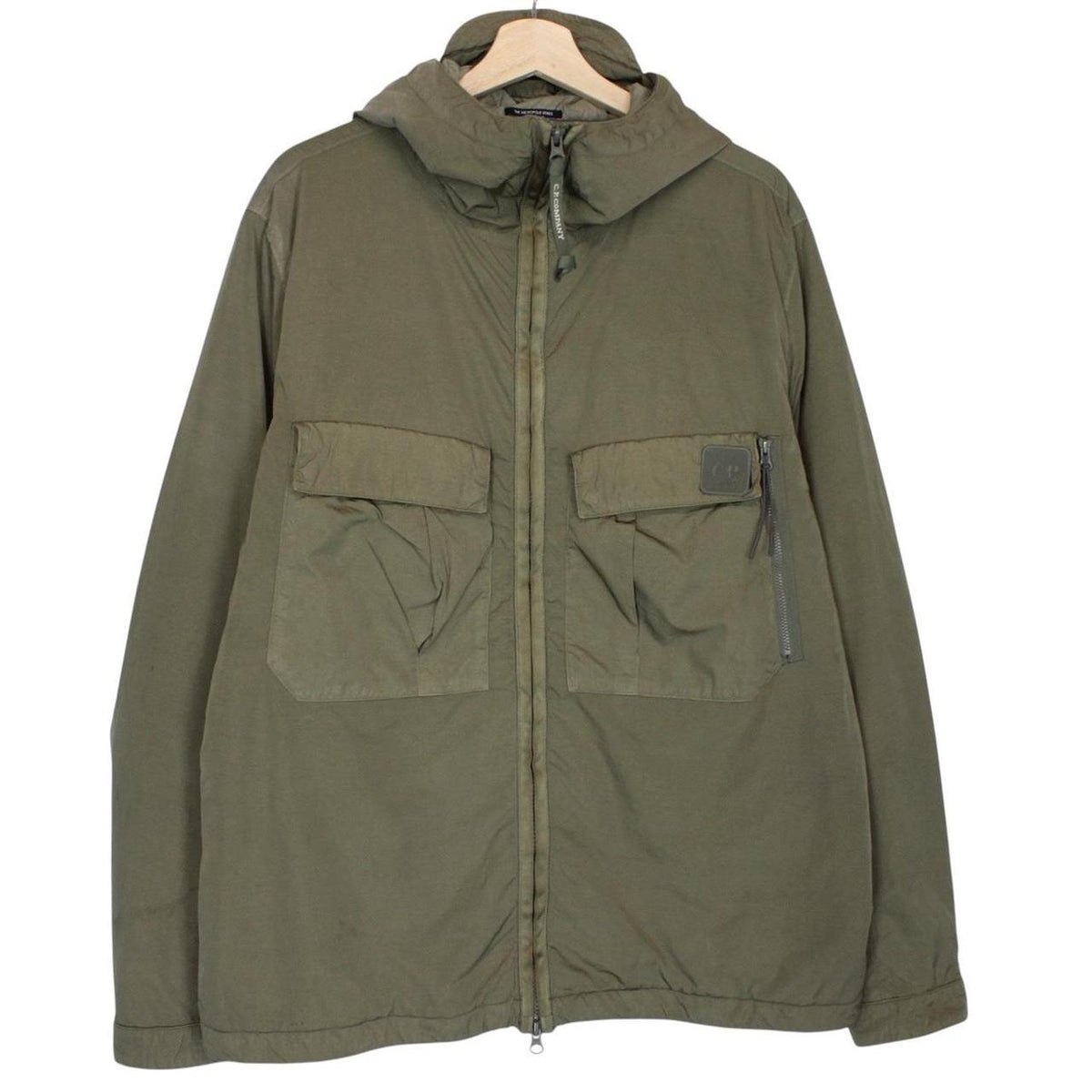 CP Company green hooded jacket with chrome detailing and logo patch on sleeve.