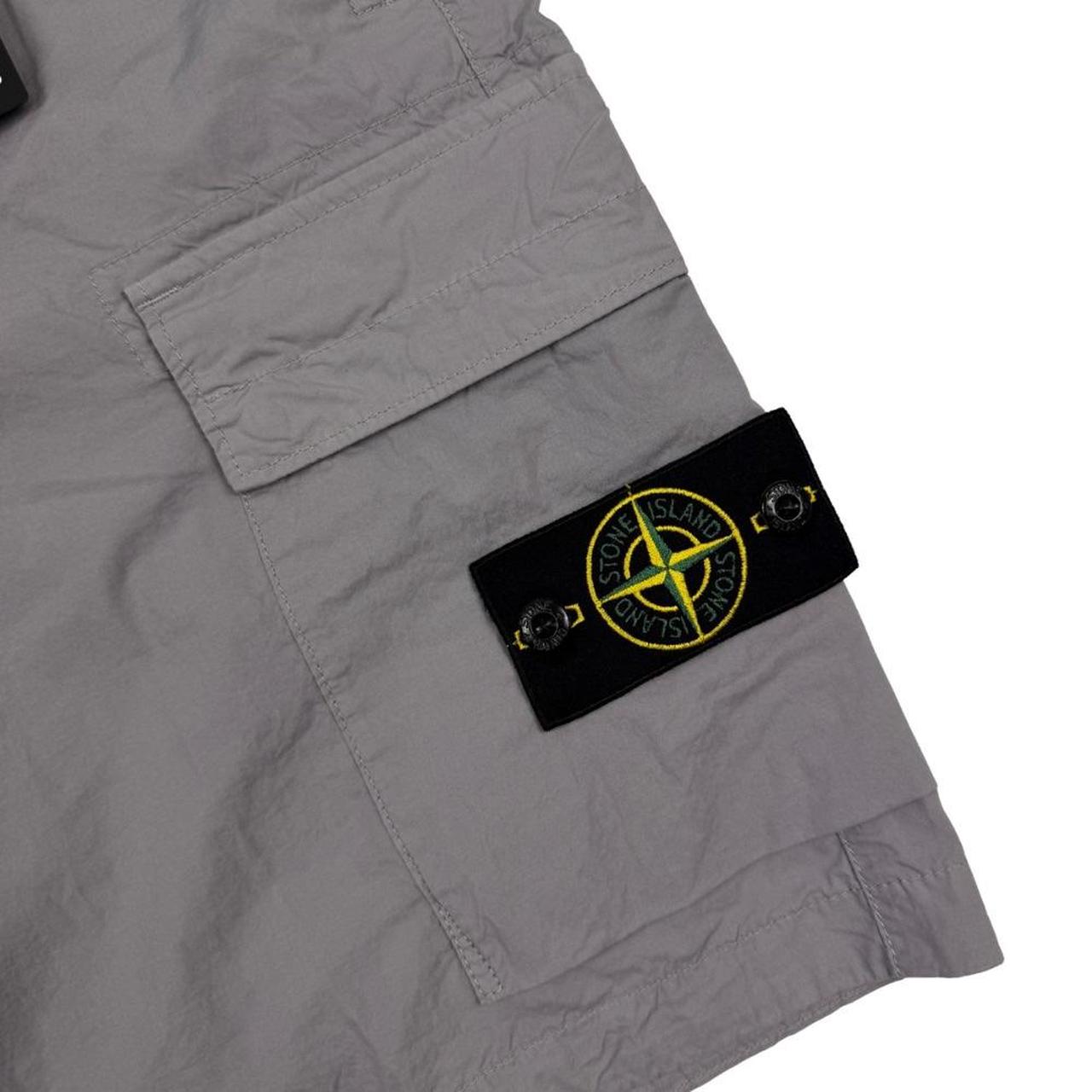 Stone Island grey cargo shorts with logo patch and multiple pockets in cotton material.