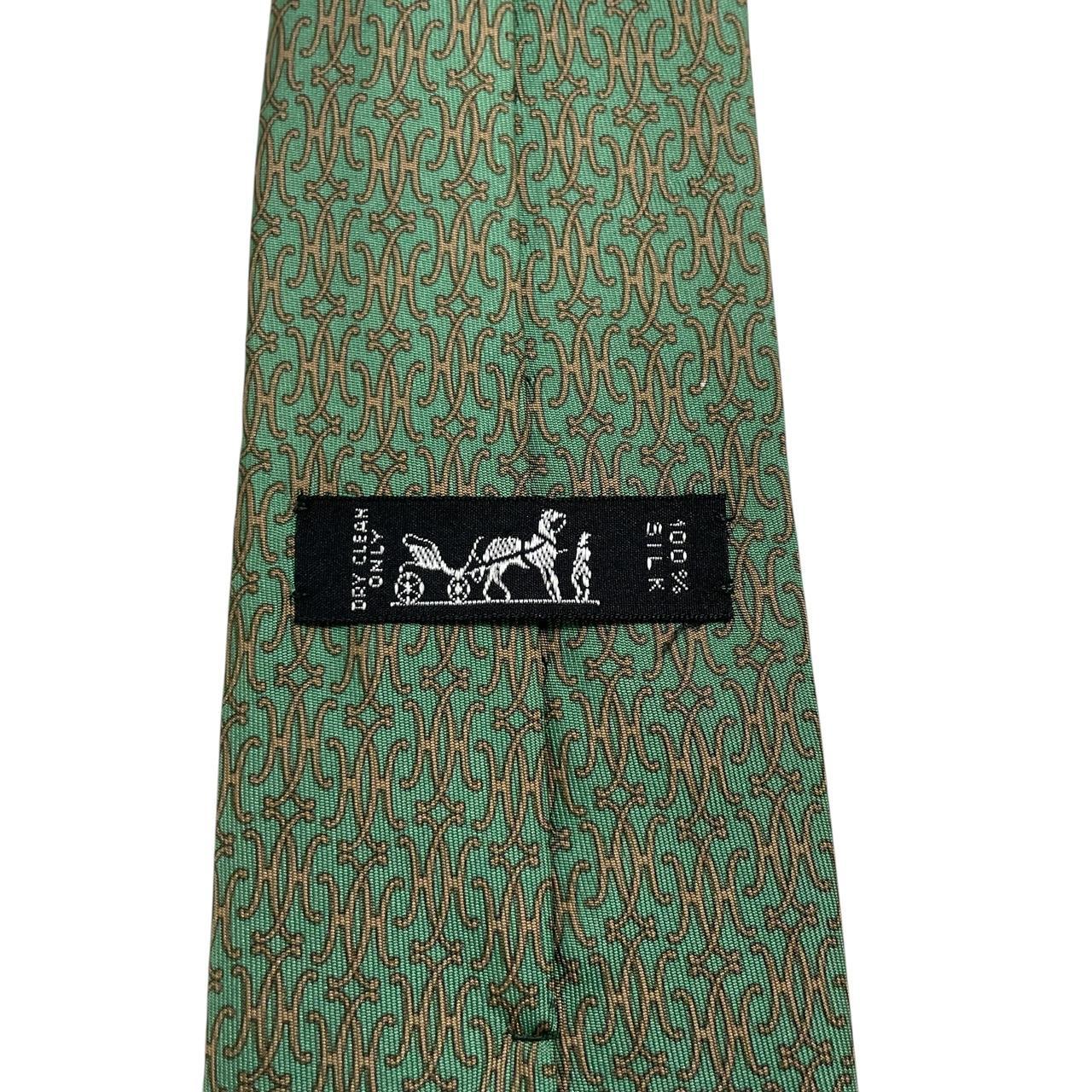 Hermes green silk tie with subtle sheen and logo detailing.