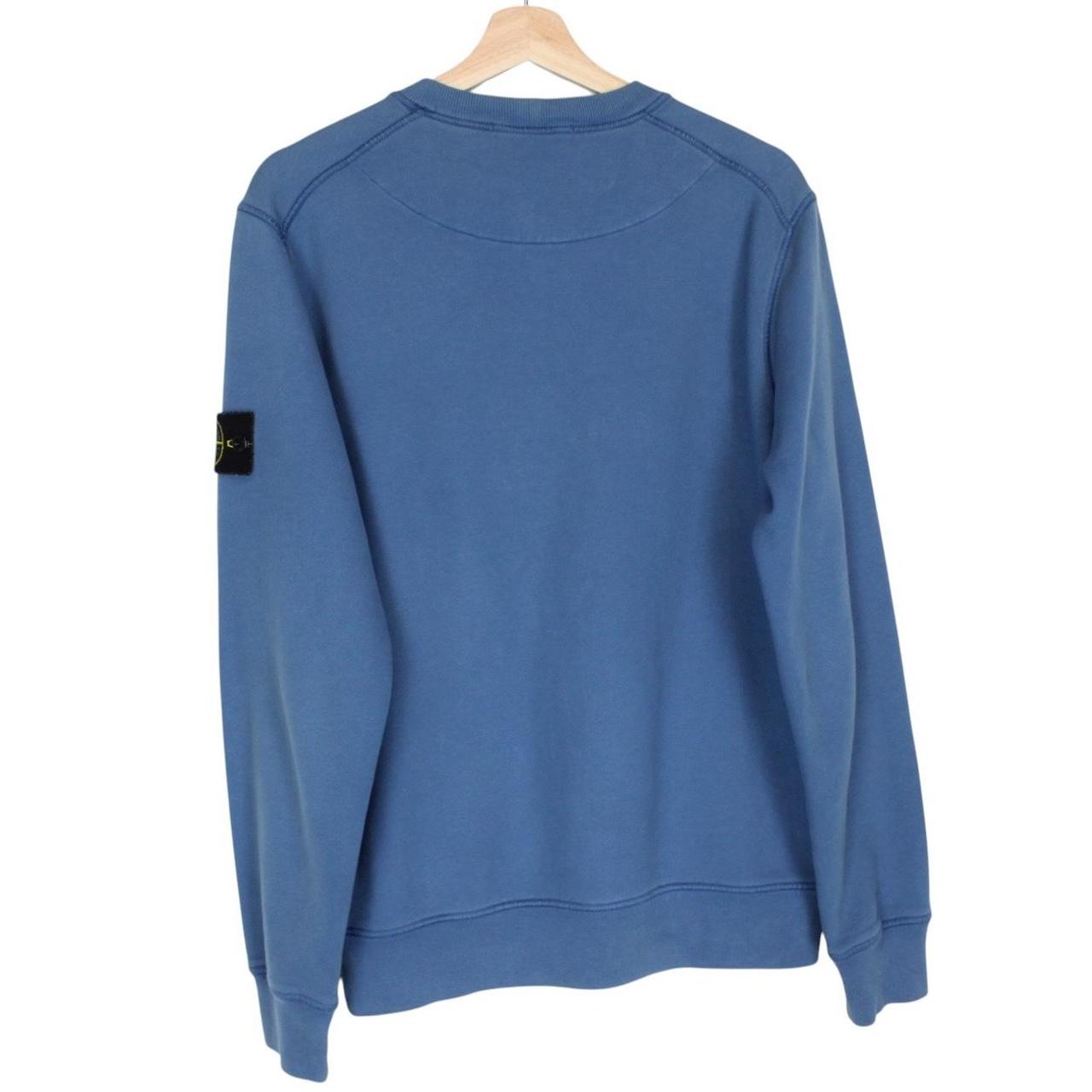 Stone Island blue cotton sweatshirt with iconic compass logo and ribbed cuffs.