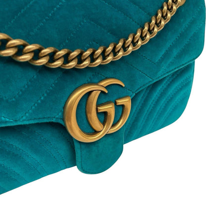 Gucci turquoise velvet shoulder bag with gold GG logo and green accents.