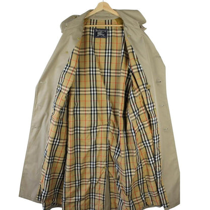 Burberry beige double-breasted belted trench coat with classic check lining and logo detail.