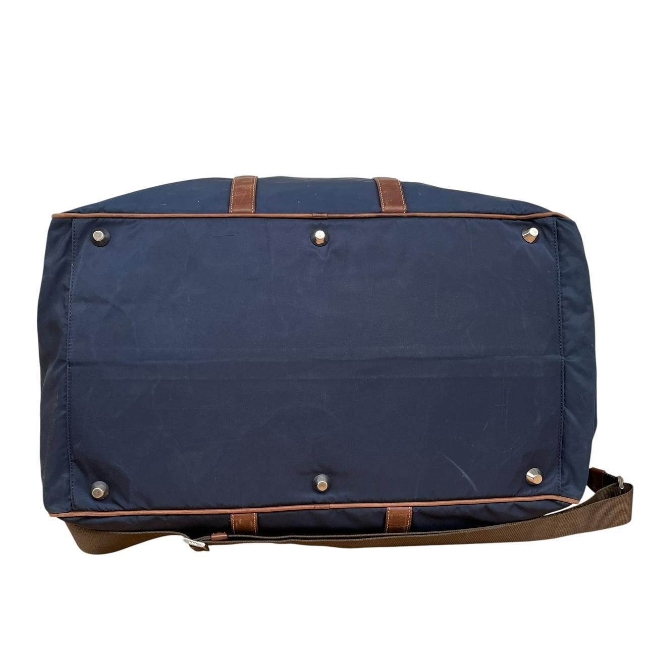 Prada navy blue and brown nylon duffel bag with signature logo and minimal wear.