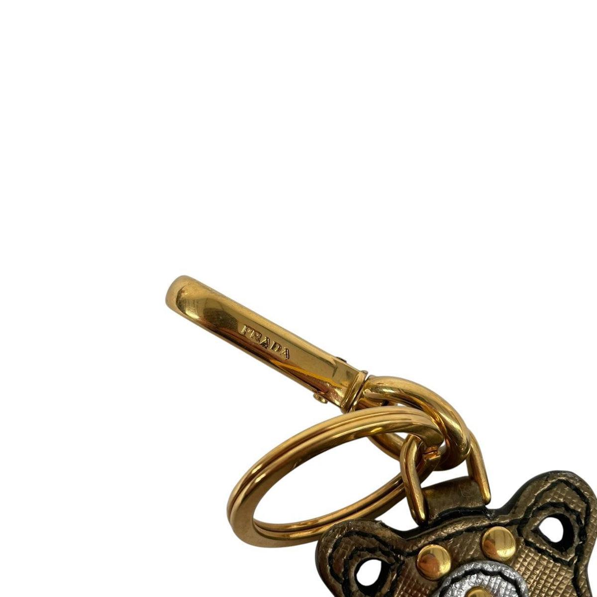 Prada brown and gold teddy bear bag charm in Saffiano leather with logo detail.
