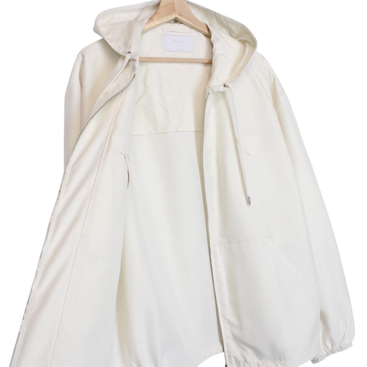 Prada cream silk hooded jacket with triangle logo and full zip detail.