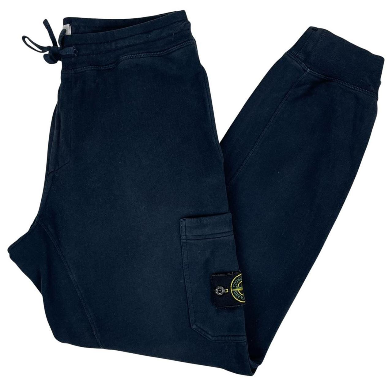 Stone Island navy blue joggers with logo patch and cotton material.