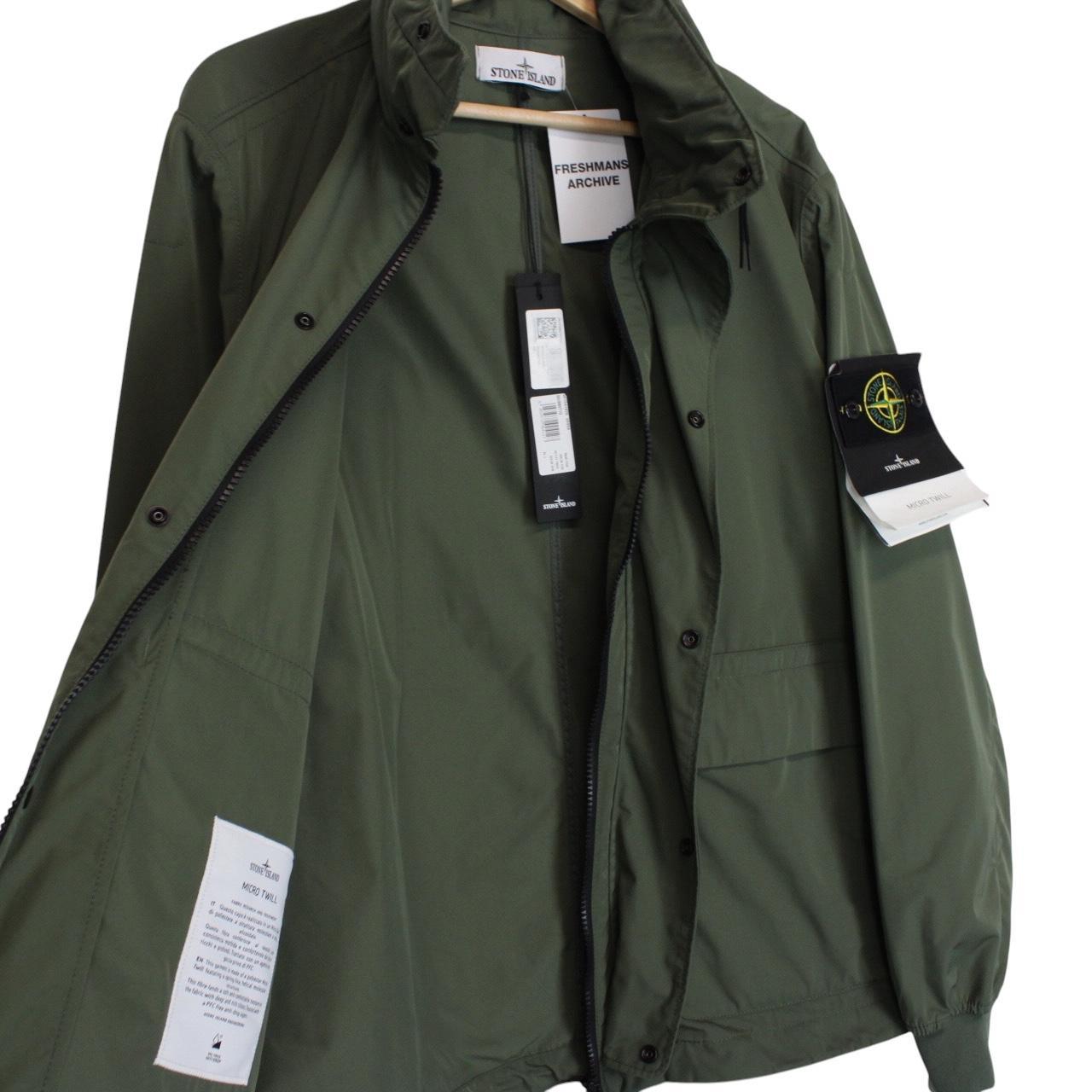 Stone Island green full zip jacket with packable hood and removable brand patch.