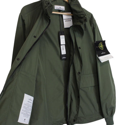 Stone Island green full zip jacket with packable hood and removable brand patch.