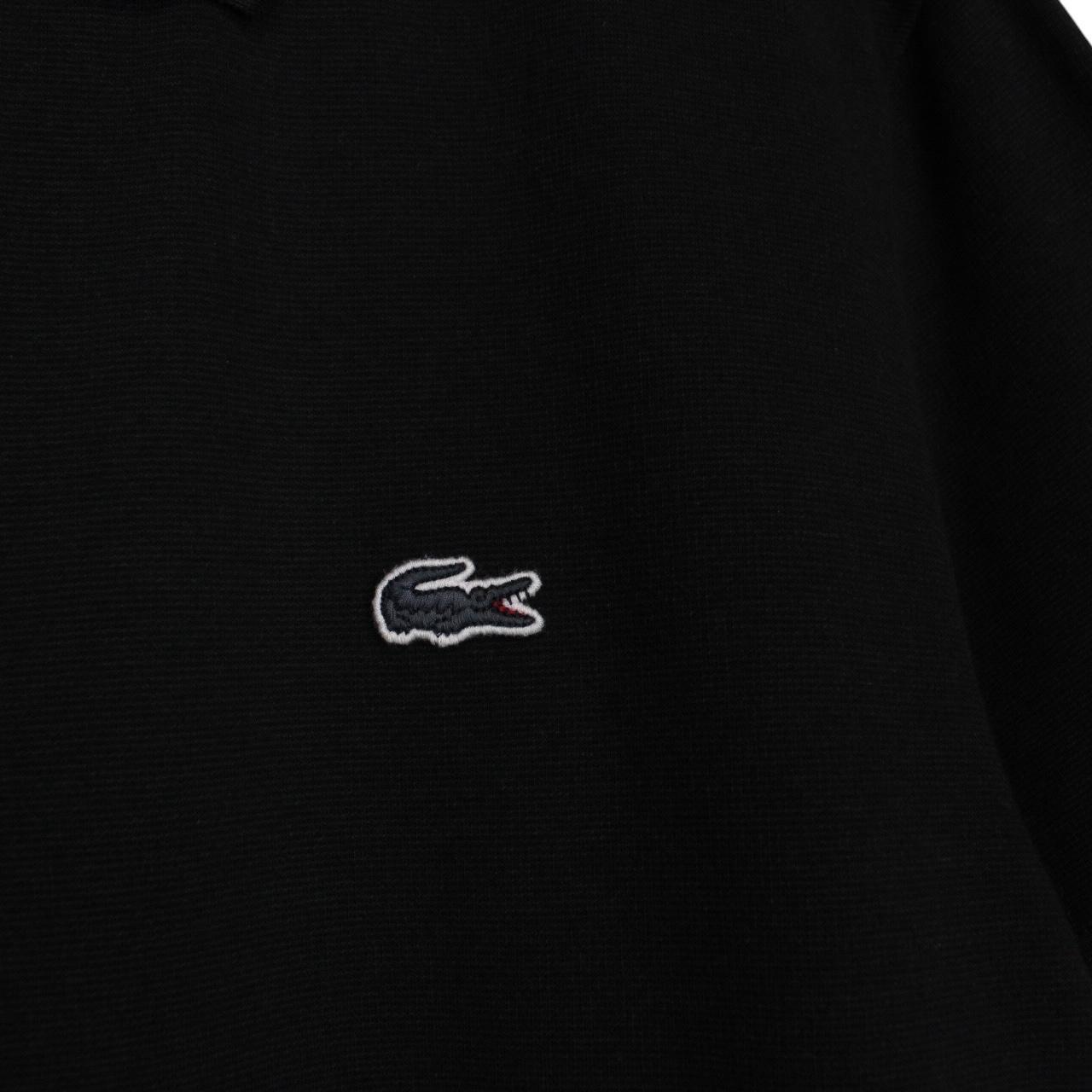 Lacoste black short sleeve polo shirt with embroidered crocodile logo, made of cotton.