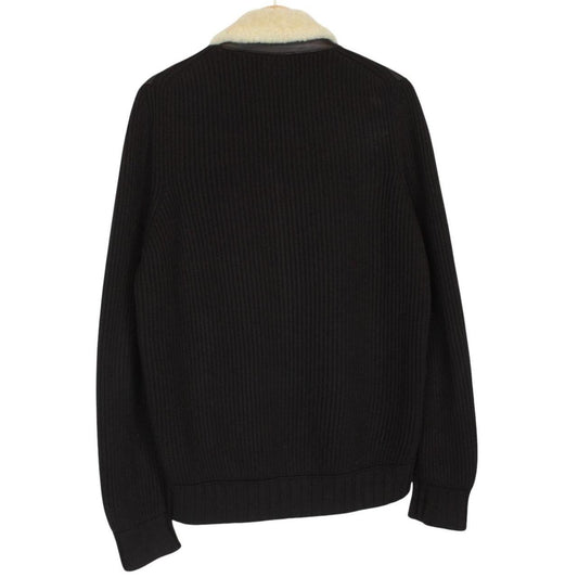 CP Company brown leather and wool shearling jacket with vintage design and logo details.