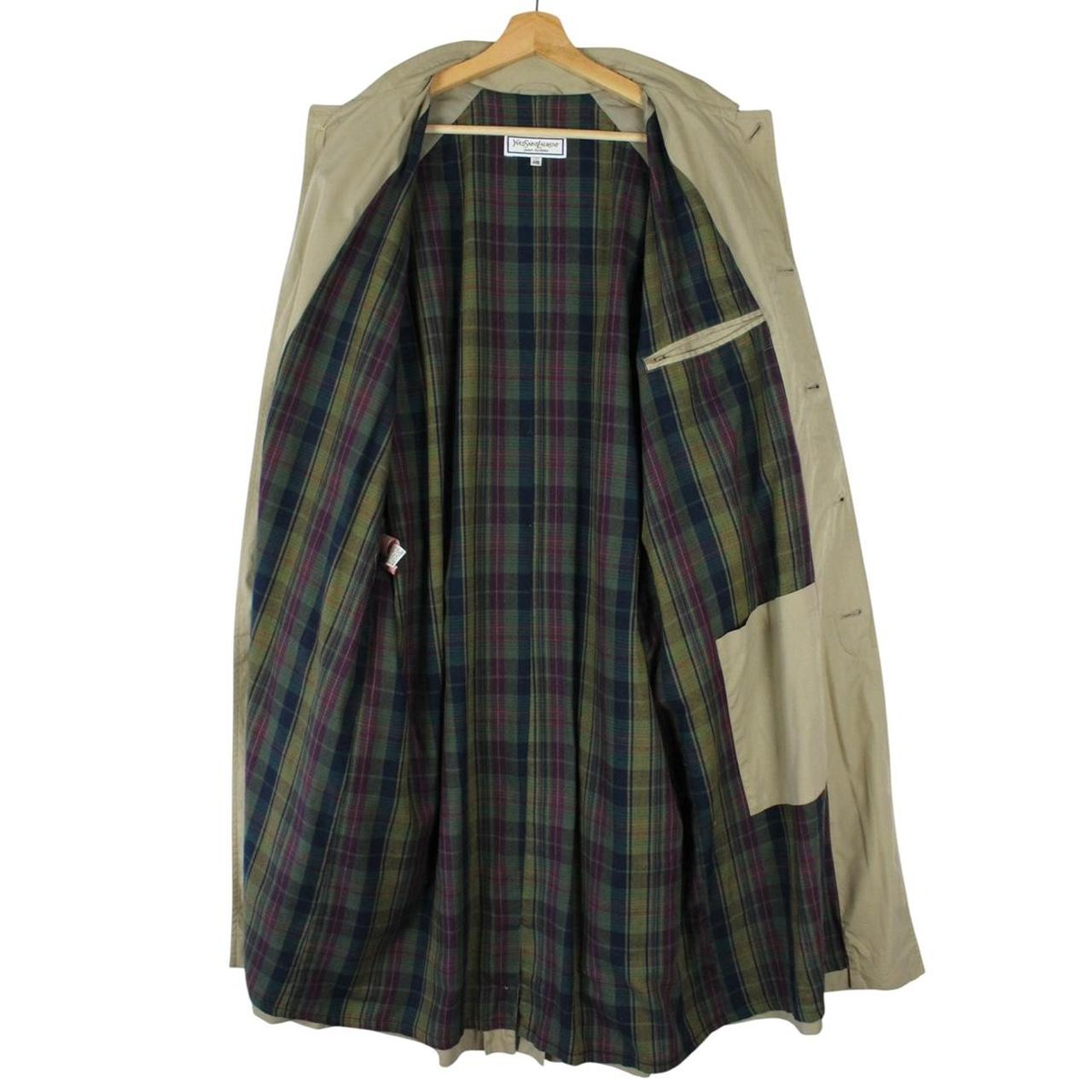 Yves Saint Laurent beige trench coat with single breasted design and belted waist.