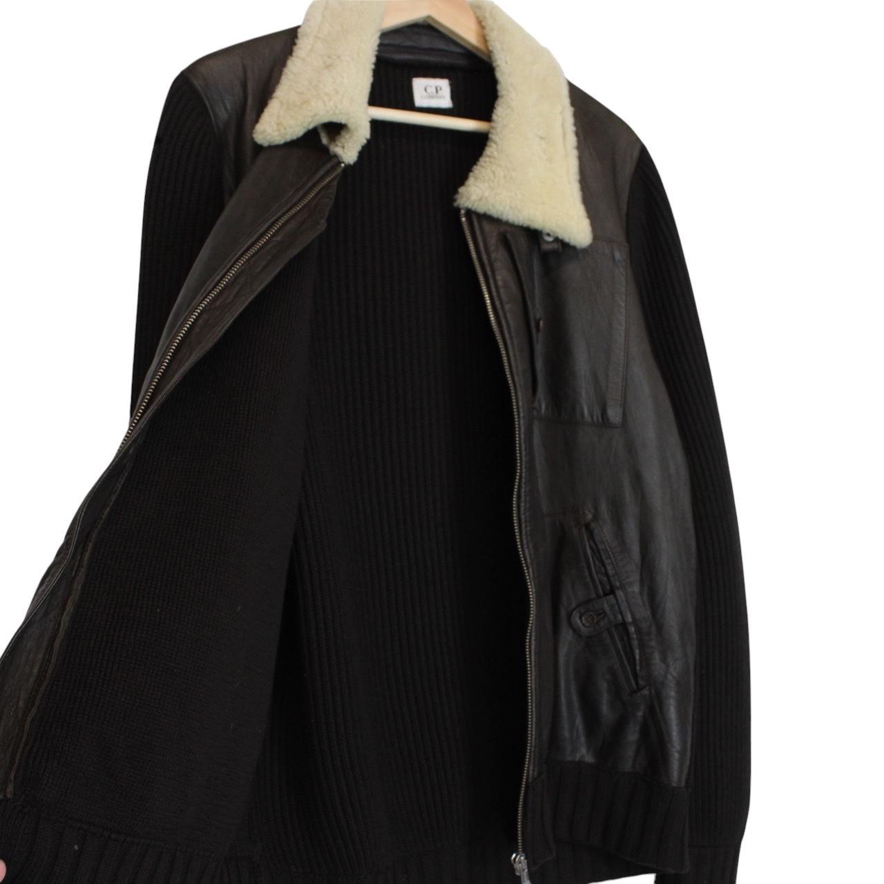 CP Company brown leather and wool shearling jacket with vintage design and logo details.