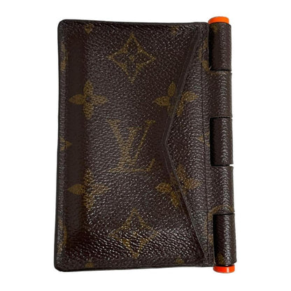 Louis Vuitton brown purse with orange metal hardware and iconic monogram pattern.