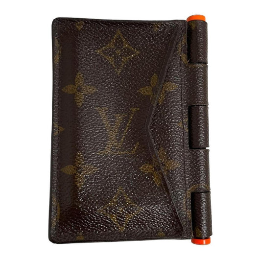 Louis Vuitton brown purse with orange metal hardware and iconic monogram pattern.
