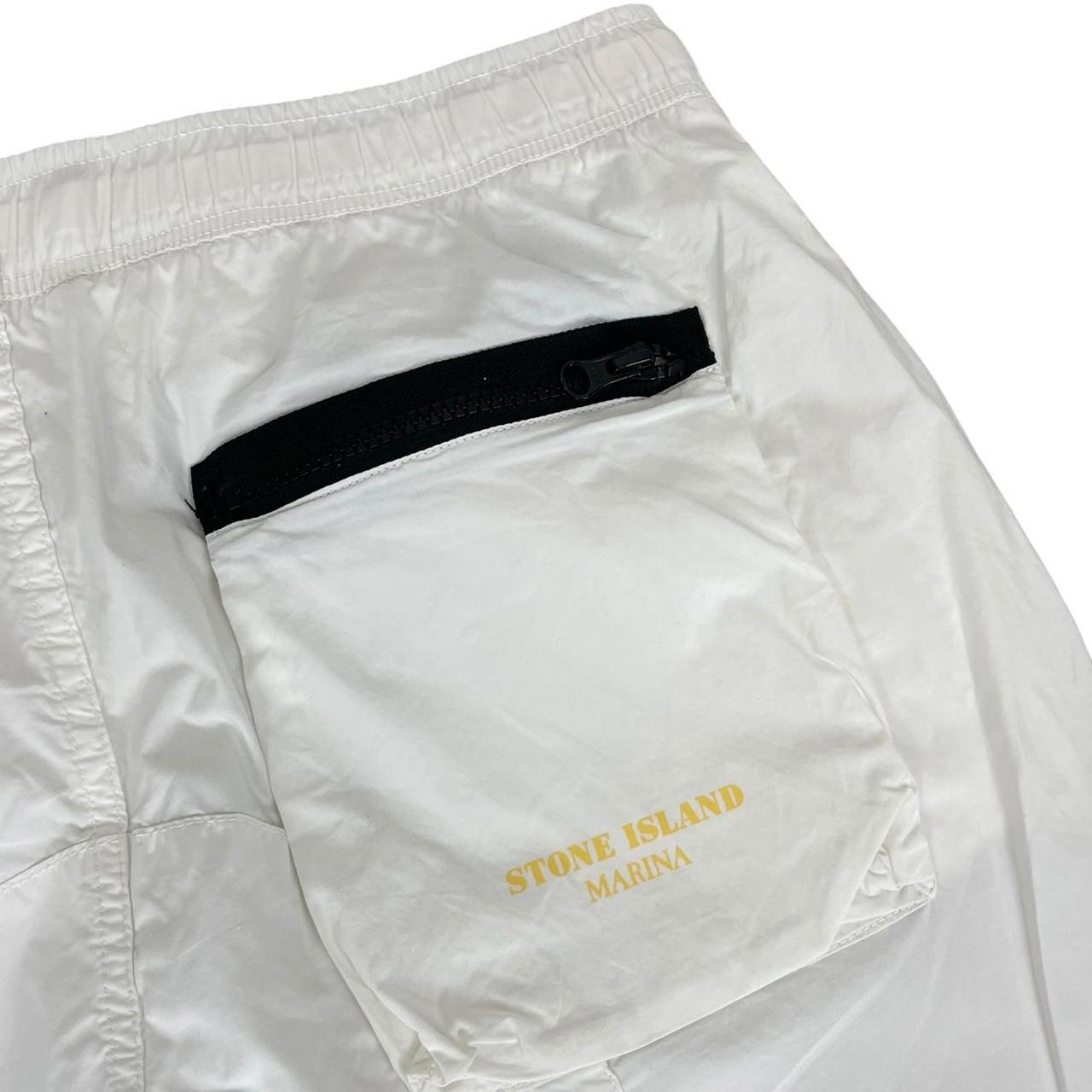 Stone Island white and yellow trousers with logo patch and RE-T fit design.