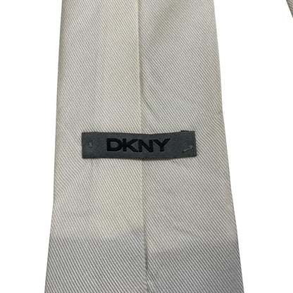 DKNY white silk tie with smooth texture and classic design.