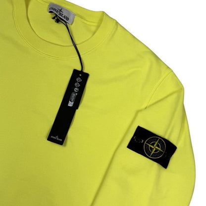 Stone Island yellow sweatshirt made from organic cotton with logo patch on sleeve.