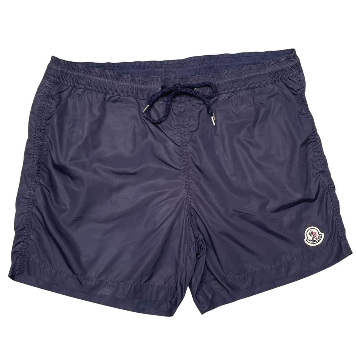 Moncler navy blue swim shorts with logo patch and lightweight nylon material.