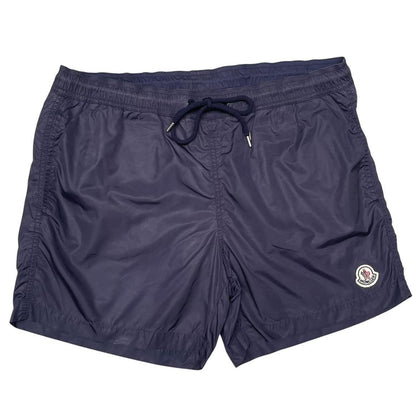 Moncler navy blue swim shorts with logo patch and lightweight nylon material.
