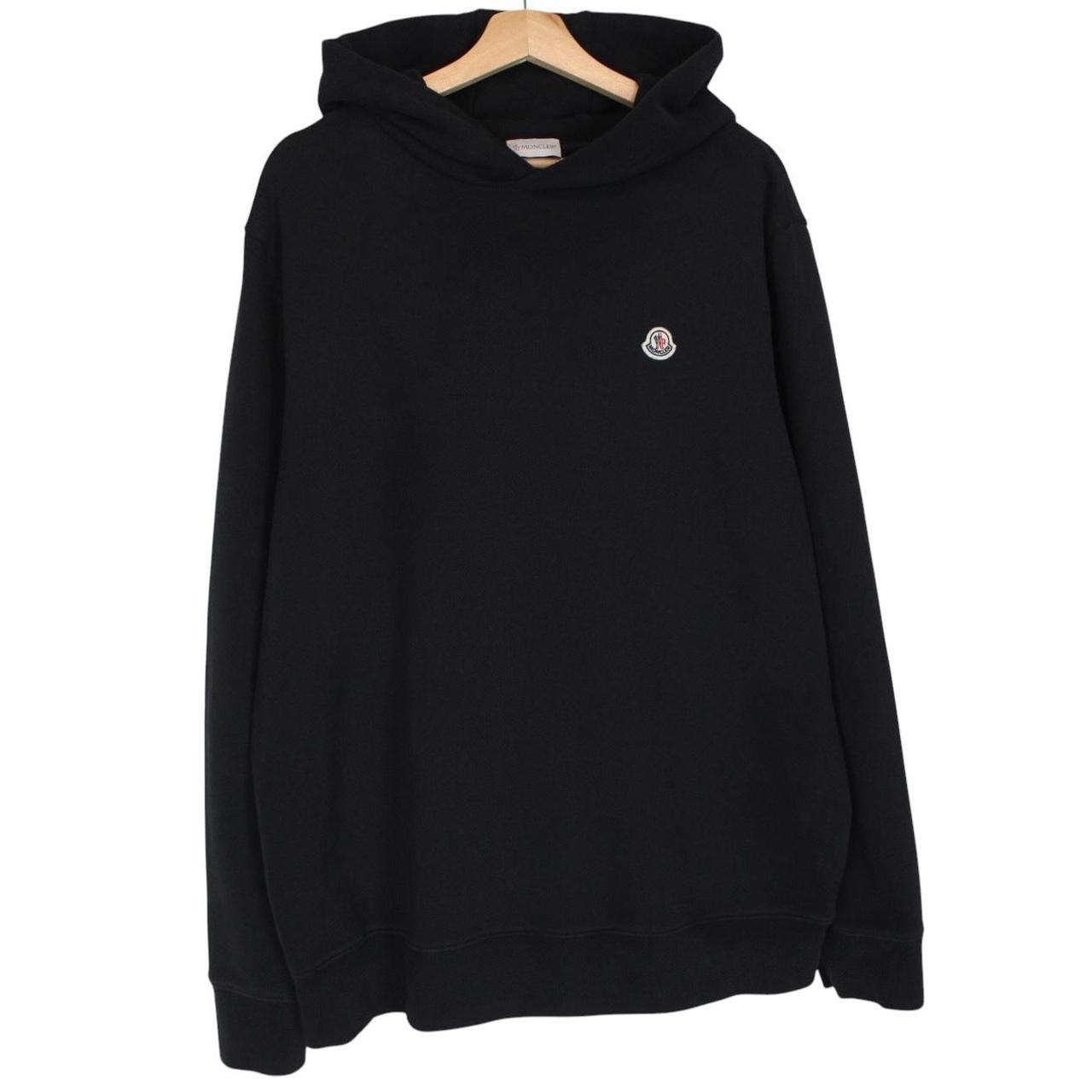 Moncler black hoodie jumper featuring logo patch and cotton material.