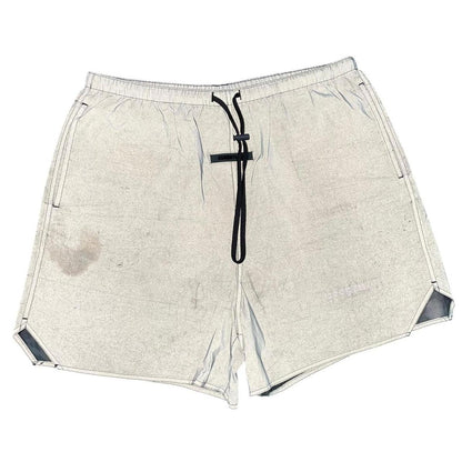 Essentials silver reflective nylon shorts with logo detail and sleek design.